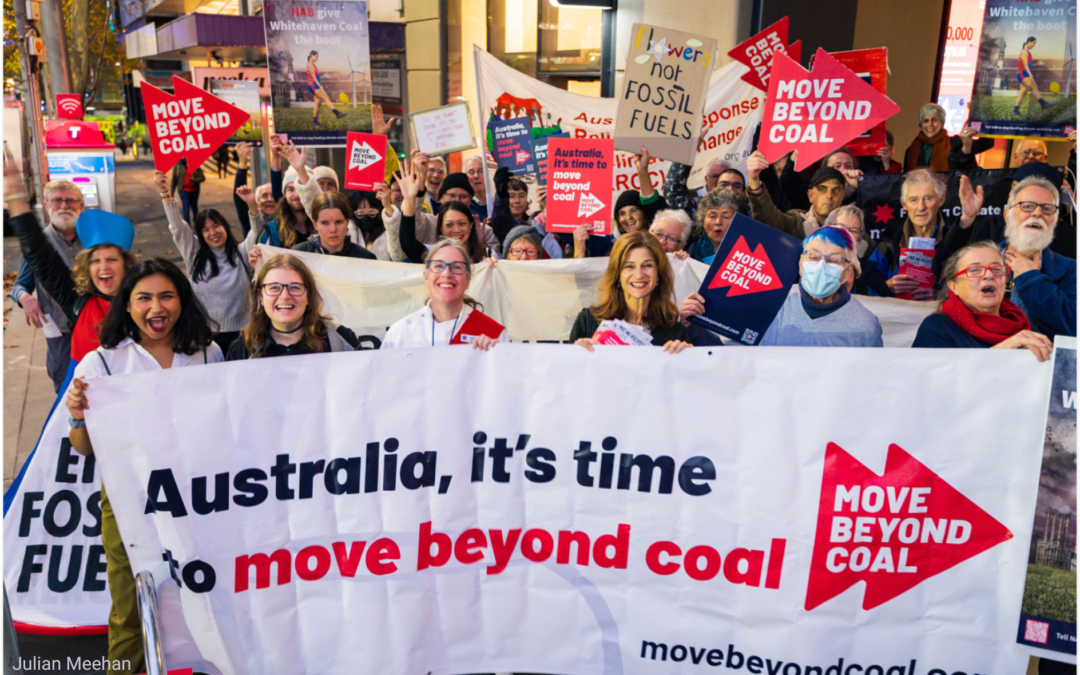 Protesters standing outside NAB holding signs saying "Move Beyond Coal" and "NAB give Whitehaven Coal the boot"